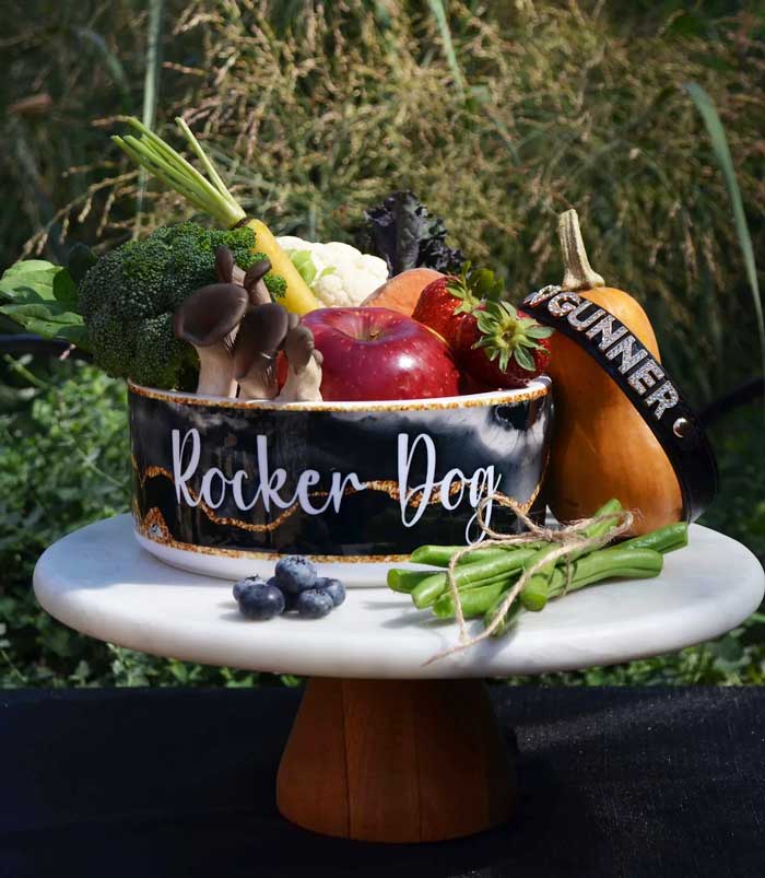 Bowl labeled 'Rocker Dog' filled with fresh fruits, vegetables, and mushrooms - representing some of the adaptogenic superfoods used in Rocker Dog’s natural dog food recipes
